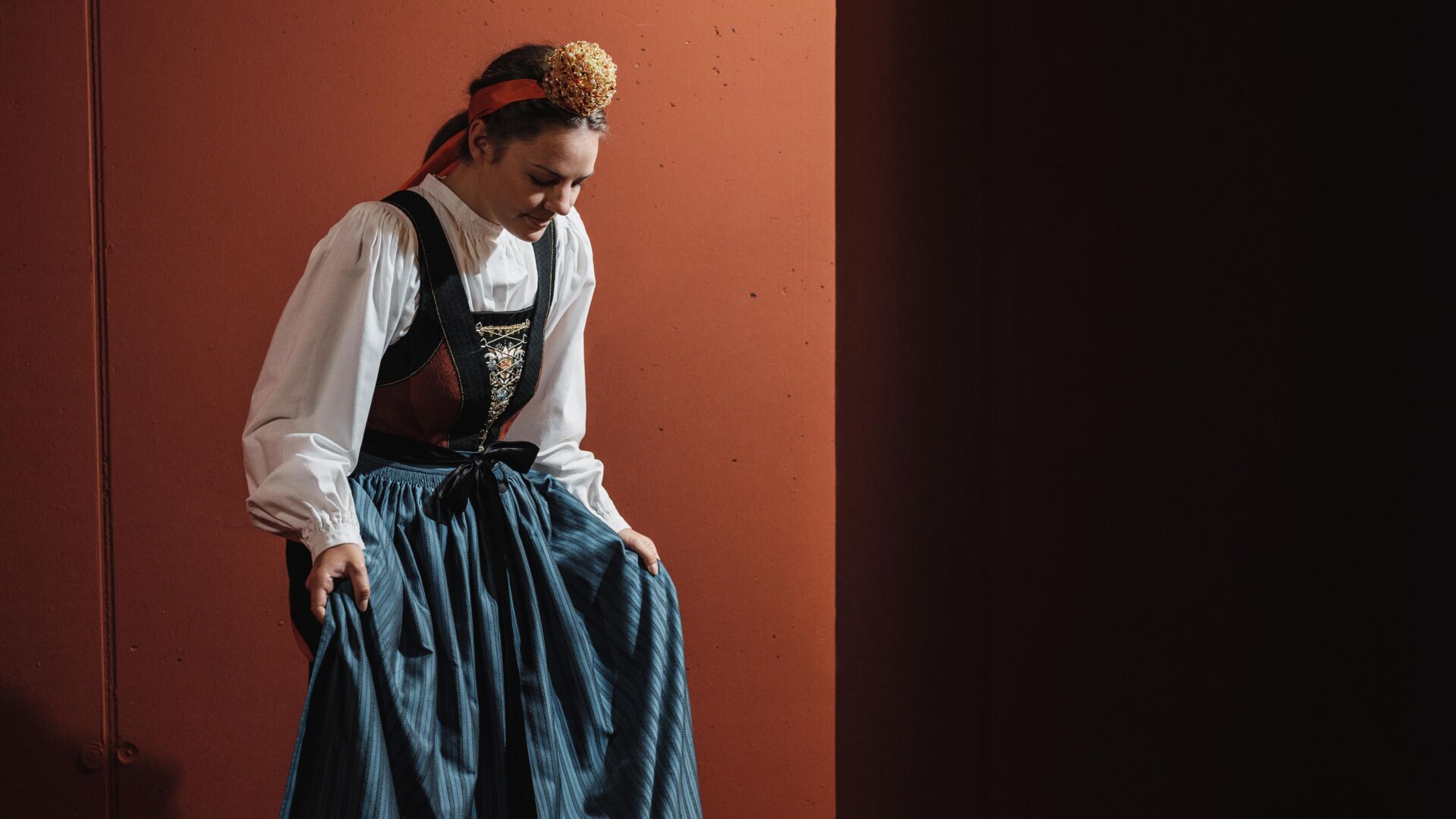Frau in traditioneller Walser Tracht mit weißer Bluse, Mieder, Schürze und Kröneli