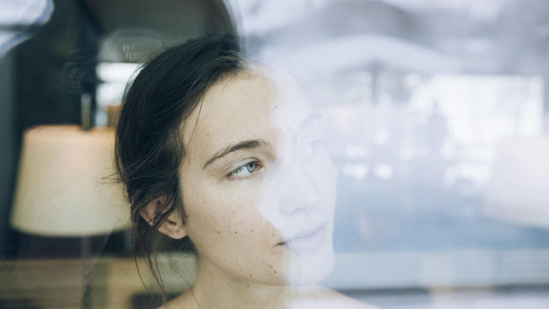 Women stares outside the window into a winter wonder land