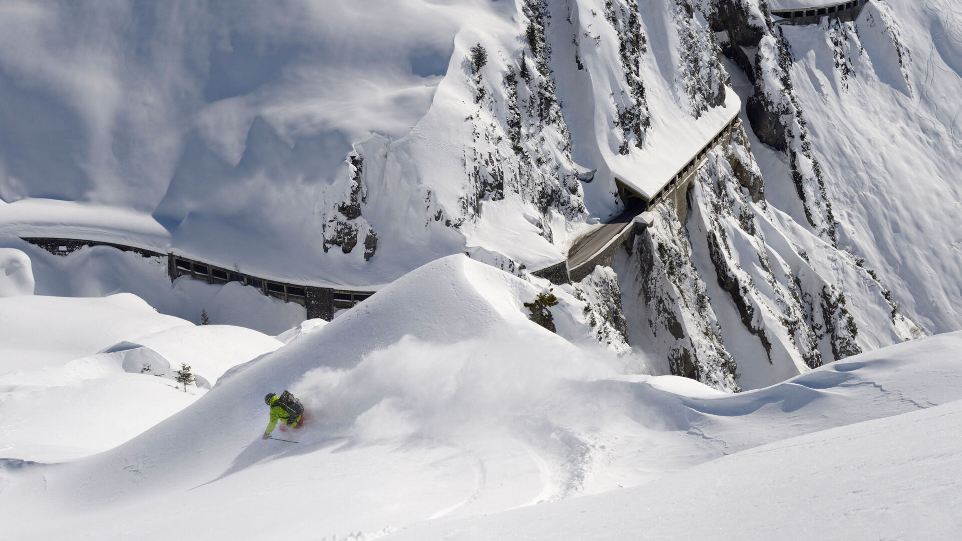 Tiefschneeabfahrt mit Blick auf die verschneite Flexengalerie in Vorarlberg