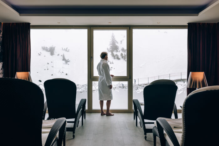 A man gazing at the winter landscape view from the spa area