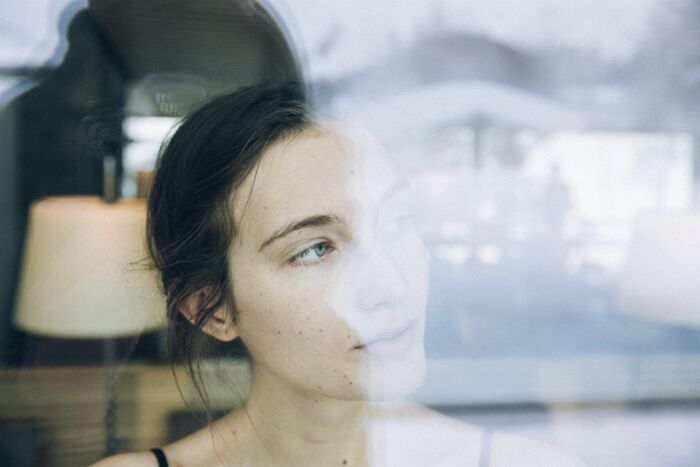 Women stares outside the window into a winter wonder land