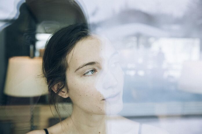 Women stares outside the window into a winter wonder land